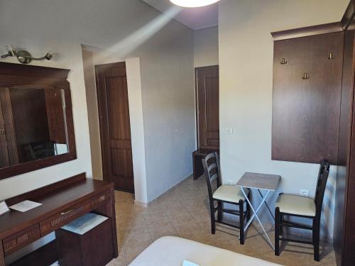 a room with a vanity and a table and chairs at Spilaio at Meteora in Kalabaka