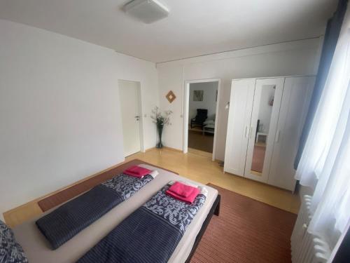 a bedroom with a bed with two pink pillows on it at Mainz Apartment near cetral station in Mainz