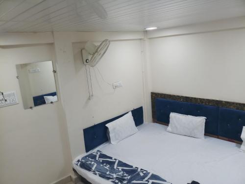 a small room with a bed in a boat at BLUE TOWER in Ujjain