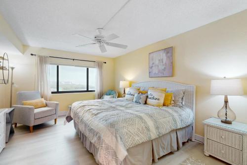 a bedroom with a bed and a ceiling fan at Corner on Cocoa in Cocoa Beach
