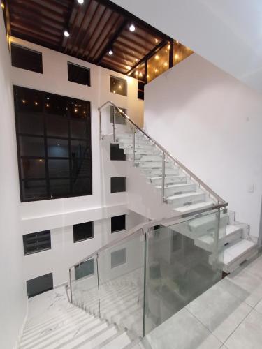 a staircase in a building with a glass railing at Alquilo Casa playa in San Antonio