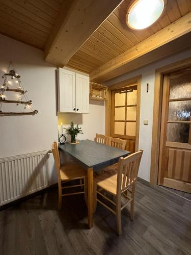 a dining room table and chairs in a kitchen at Apartmány Roudnice in Jestrabi V Krkonosich