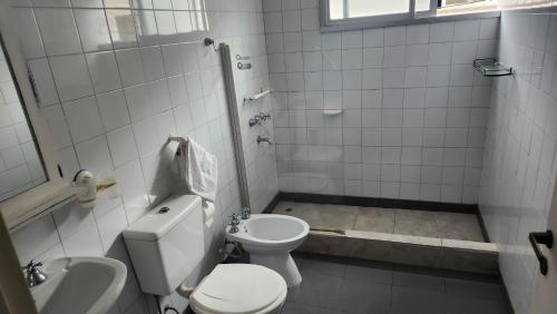 a bathroom with a toilet and a sink at Hotel Agustin Garcia in Tigre