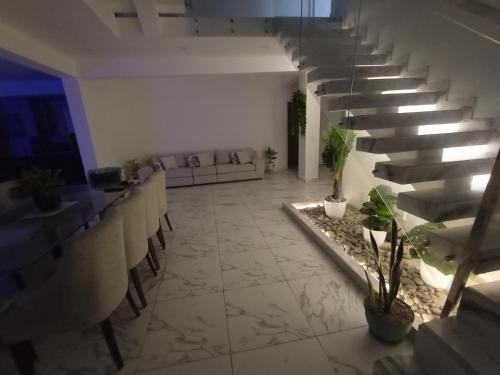 a lobby with a couch and stairs in a building at Alquilo Casa playa in San Antonio