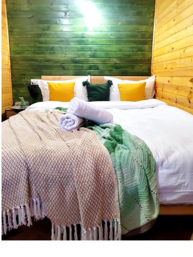a bedroom with a bed with a blanket on it at Gradina Tisa in Comăneşti