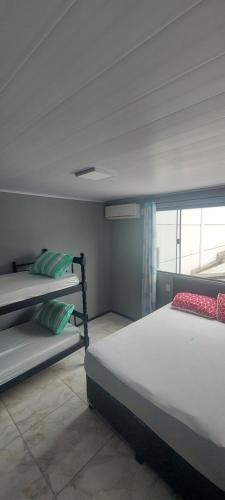 a bedroom with two bunk beds and a window at Casa Couto in Penha