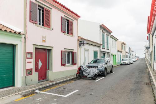a street with cars parked on the side of the road at WelcomeBuddy - Azorean Ocean House in Ribeira Grande
