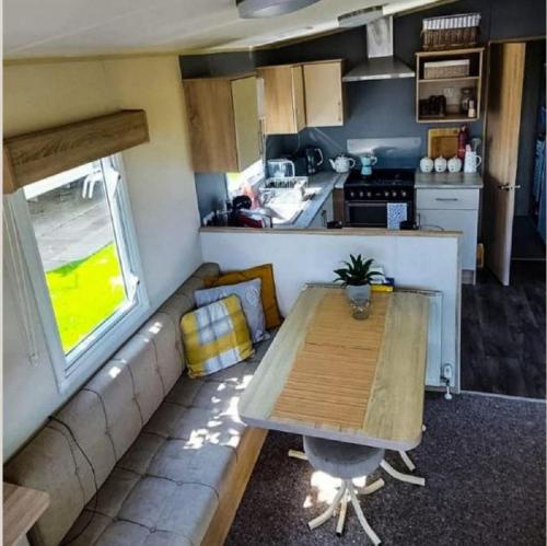 a living room with a table and a couch at Great 8 Berth Caravan At Sand Le Mere In Yorkshire Ref 71001i in Tunstall