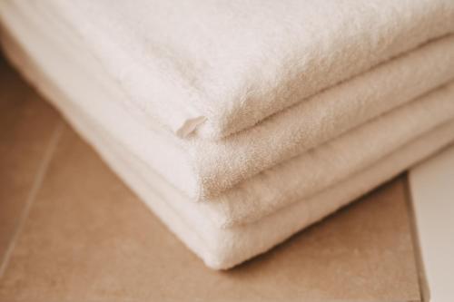 a pile of white towels sitting on a table at Dorf 70 in Eichenberg