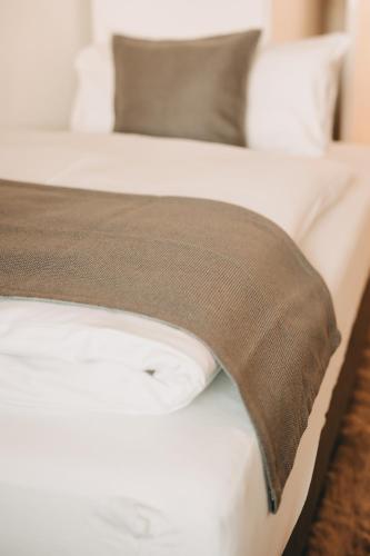a close up of a bed with a brown blanket on it at Dorf 70 in Eichenberg