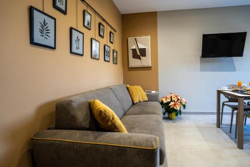 a living room with a couch and a table at Virdamuri - Etna Country Resort in Giarre