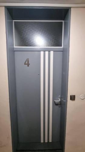 a door with stripes on it in a room at STUDIO APARTMAN 404 in Vukovar