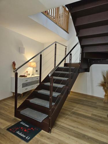 a staircase in a house with a black railing at Arduino41 in San Martino Canavese