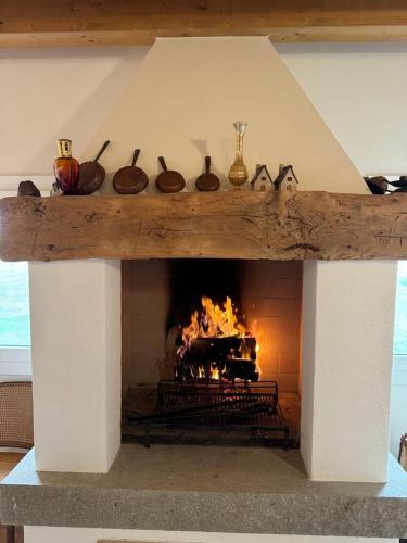 a stone fireplace with a fire in it at b&b Agriturismo San Matteo in Chiavicone