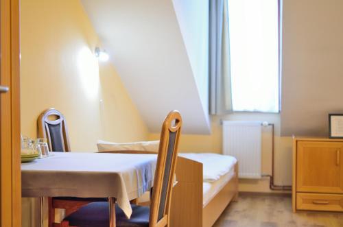 a small room with a bed and a table at WenderEDU Business Center in Wrocław