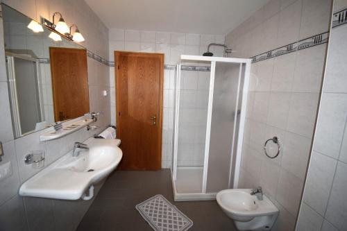 a bathroom with a sink and a shower and a toilet at Hotel Montana in Solda