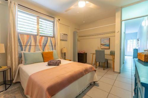 a bedroom with a bed and a table and a desk at Casa Piña Suave #2 Jungle seclusion close to ocean in Rincon