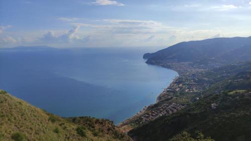 a view of a large body of water from a hill at Vento di Mare in Piraino