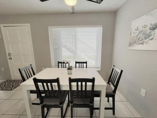 a dining room with a white table and chairs at Beautiful Waterfront Beach Condo With Dock in St Pete Beach