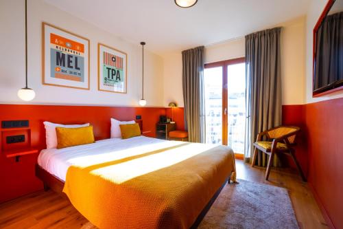 a bedroom with a large bed in a red room at The People - Paris Nation in Paris