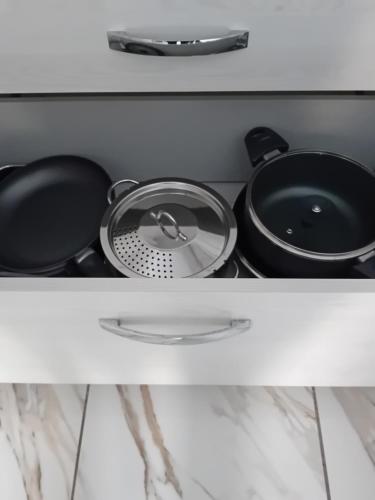 a shelf with pots and pans in a kitchen at Villa Azzurra in Monfalcone