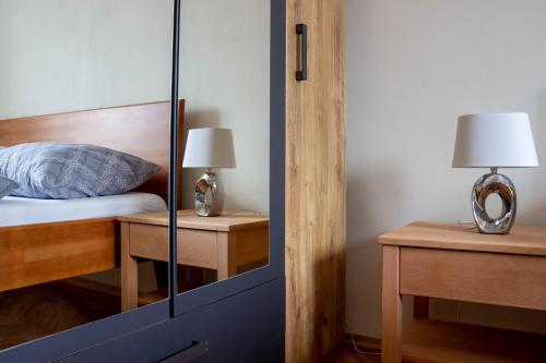 a bedroom with a bed and a glass door at AS apartmán sever in Košice