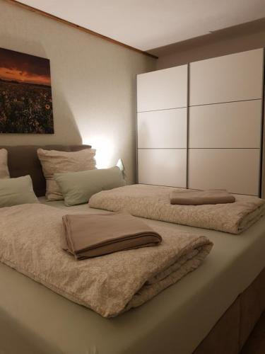 a bedroom with two beds with towels on them at Ferienwohnung Zur Alten Gärtnerei in Hürtgenwald