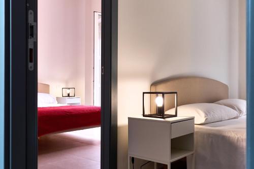 a bedroom with a bed and a table with a lamp at Vento di Mare in Piraino