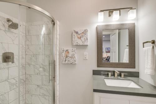 a bathroom with a shower and a sink and a mirror at Bright and Modern Home 2 Mi to Presque Isle Airport in Presque Isle