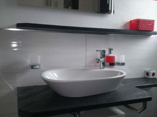 a white sink on a counter in a bathroom at BIENE`S Ferientraum in Reit im Winkl