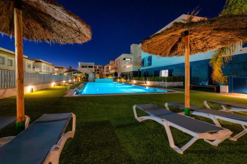 a villa with a swimming pool at night at Playa Flamenca - Turquesa del Mar - great sea view! in Playa Flamenca