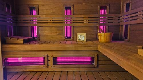 an inside view of a sauna with pink lighting at Domek pod Świerkami & Jacuzzi in Jelenia Góra