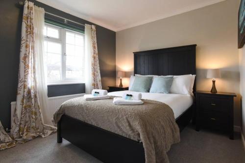 a bedroom with a large bed with two towels on it at Spacious Family Home Sleeps 6 in Alverstoke
