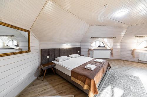 a bedroom with a bed in a white room at Diamond Resort White in Bukovel