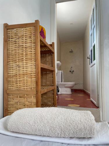 a bedroom with a ladder and a bathroom with a toilet at Cozy Surf House in Taghazout