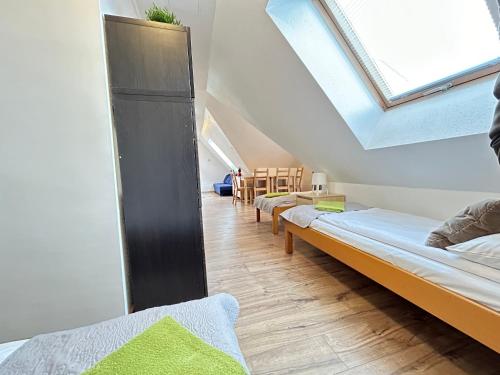 a room with three beds and a skylight at Willa Nad Strumykiem in Szczawnica