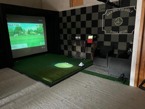 a room with a screen with a video game on it at The Old Post Office Lodge in Enniskillen
