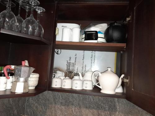 a cupboard filled with lots of dishes and cups at Villa Ali in Galle