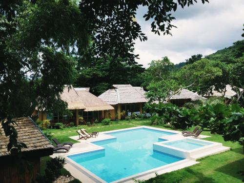 a resort with a swimming pool in the yard at La Natura Resort in Coron