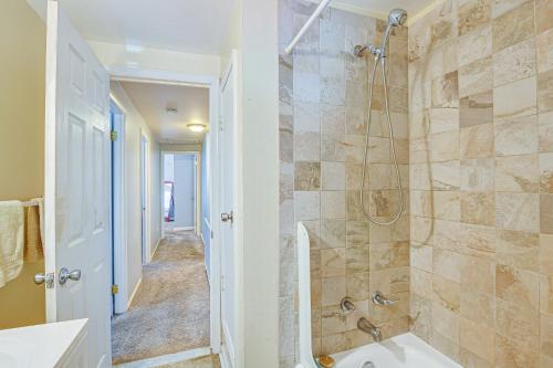 a bathroom with a shower and a tub and a sink at Maryland Abode with Patio Near Baltimore Harbor in Baltimore