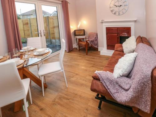 a living room with a couch and a table at Sŵn Y Môr in Burry Port