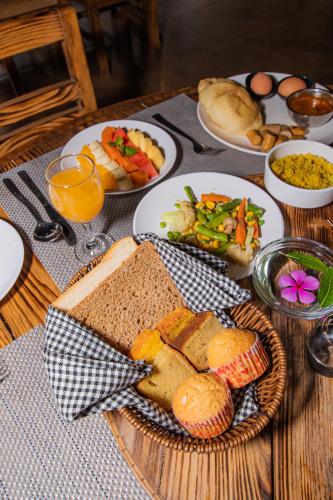 a table with plates of bread and other food on it at Majheri Resort and Spa in Pokhara