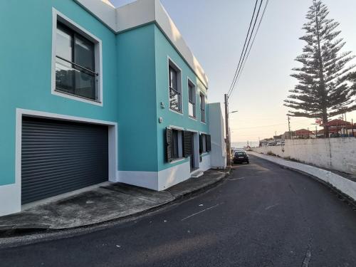 a blue building on the side of a street at Villa Mar Azul - Mosteiros Beach in Mosteiros