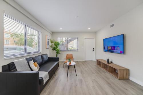 a living room with a couch and a tv at Heart of Little Havana Awaits in Miami
