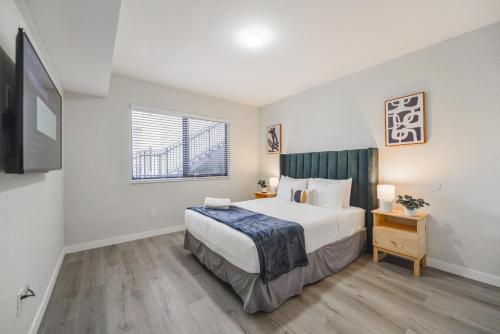 a bedroom with a large bed and a television at Heart of Little Havana Awaits in Miami