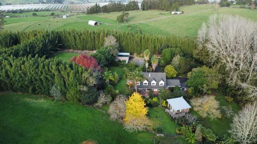 an aerial view of a house in a field at Horse Shoe Manor in Paihia