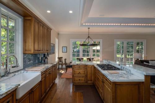 a large kitchen with wooden cabinets and a large island at Gimlet Family Home Close to Lift with Hot Tub! in Hailey