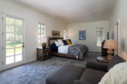 a bedroom with a bed and a couch at Gimlet Family Home Close to Lift with Hot Tub! in Hailey