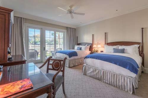 a hotel room with two beds and a table at Montage Palmetto Bluff in Bluffton