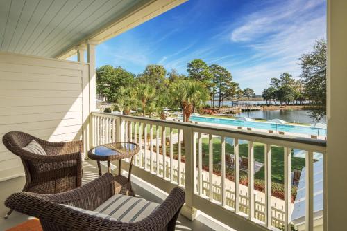 a balcony with chairs and a view of a pool at Montage Palmetto Bluff in Bluffton